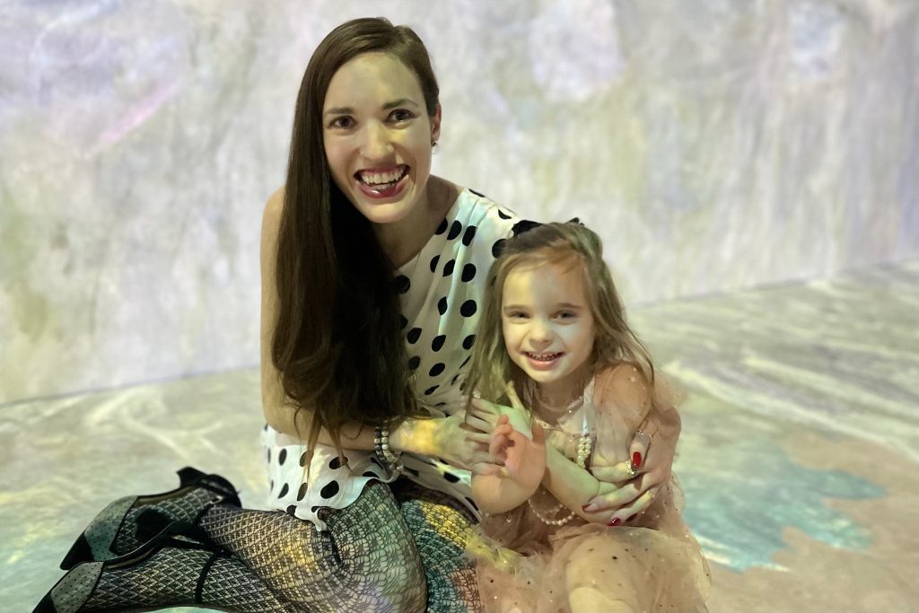 mother and toddler daughter in immersive monet exhibit at the lume